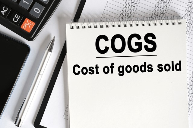 A calculator and notepad with the words "COGS - Cost of goods sold" mapping to the theme of this post, which is monitoring your restaurant's cost of goods sold.