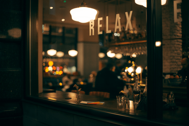 The outside of a restaurant window with the word "relax" on it, just as you'll relax with the Stellar Menus Intelligent Menu Platform.