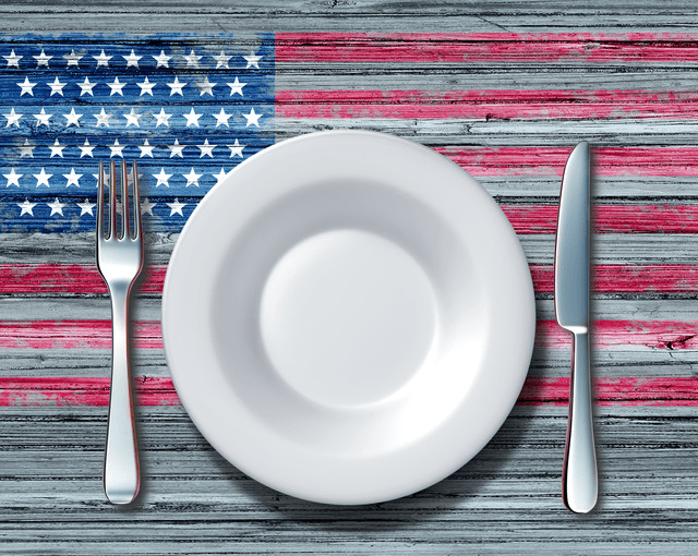 A vector image of an empty plate with a knife and fork, sitting on a wooden table painted with the U.S. flag, to illustrate food insecurity and how restaurants can help while promoting charity drives on social media.