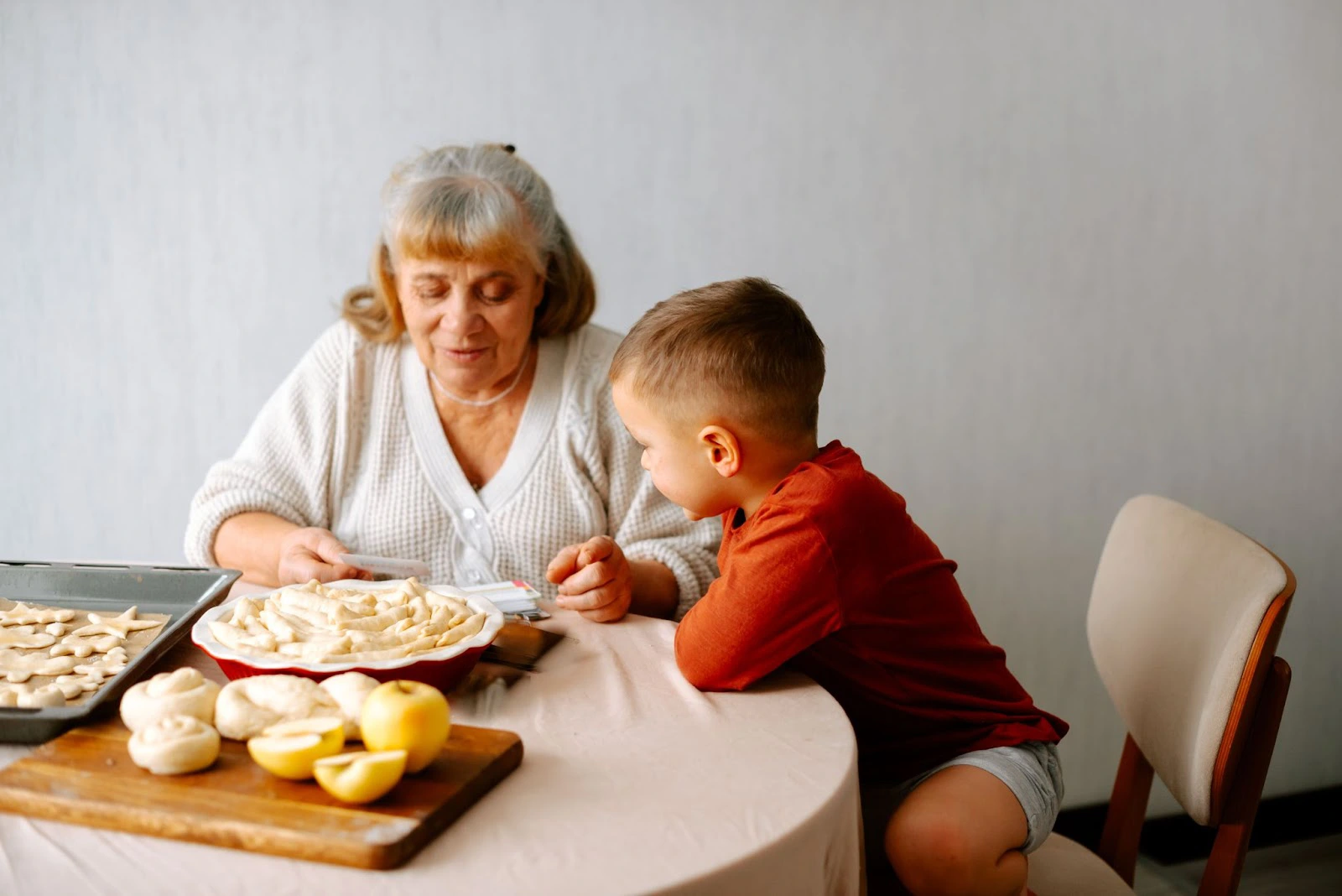 Grandmother and grandchild preparing pastries
