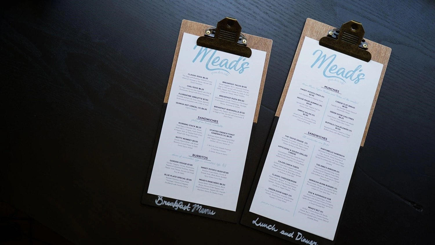 Two clipboards with menus on them showcasing culinary creativity and menu management.