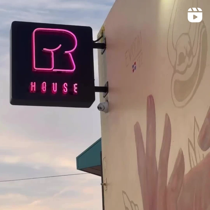 A neon sign welcoming guests to R House, Chef Rocco Carulli's Miami restaurant