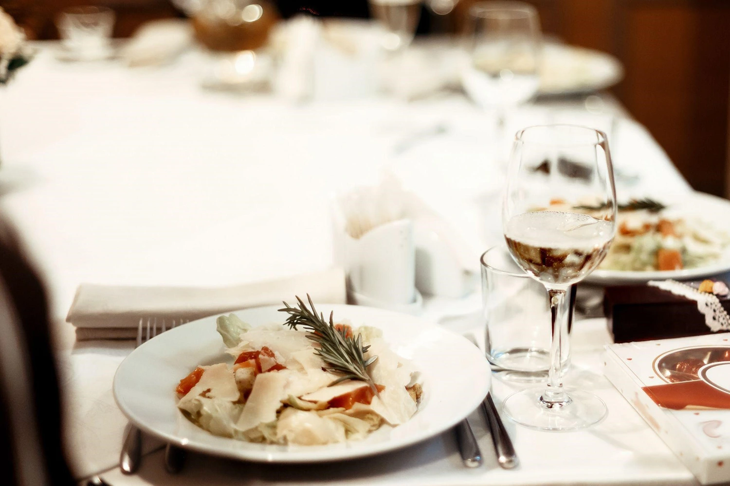 Create a seasonal menu with a table displaying food and wine.