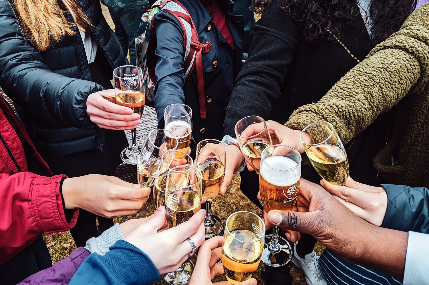 Restaurant holiday guide: A group of restaurant staff toasting with champagne glasses after a successful holiday season.