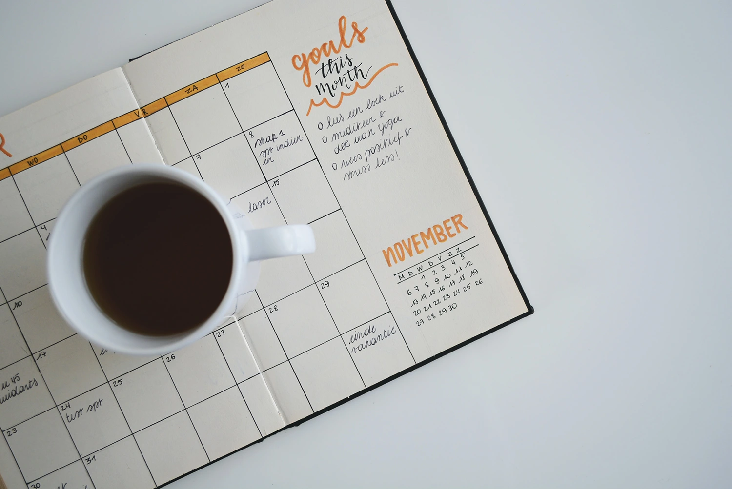 A calendar coupled with a cup of coffee represents restaurant marketing.