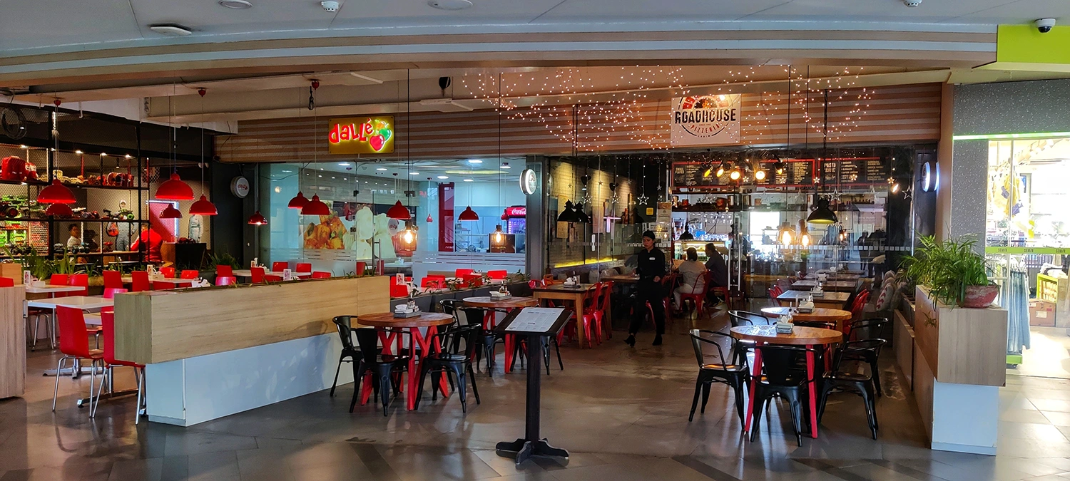 The interior of a restaurant with red tables and chairs featuring Restaurant marketing.